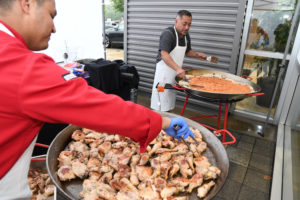 Caterers preparing paella at Road to Home 2019
