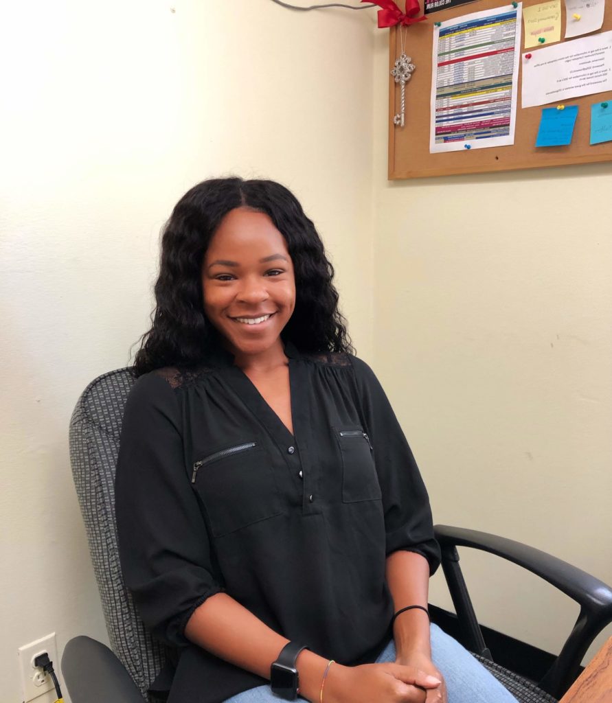 Sierra, summer intern, sitting at desk