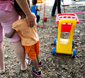 child and teacher on playground