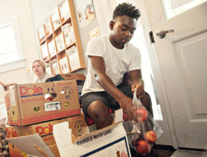 Volunteer bagging apples at food pantry