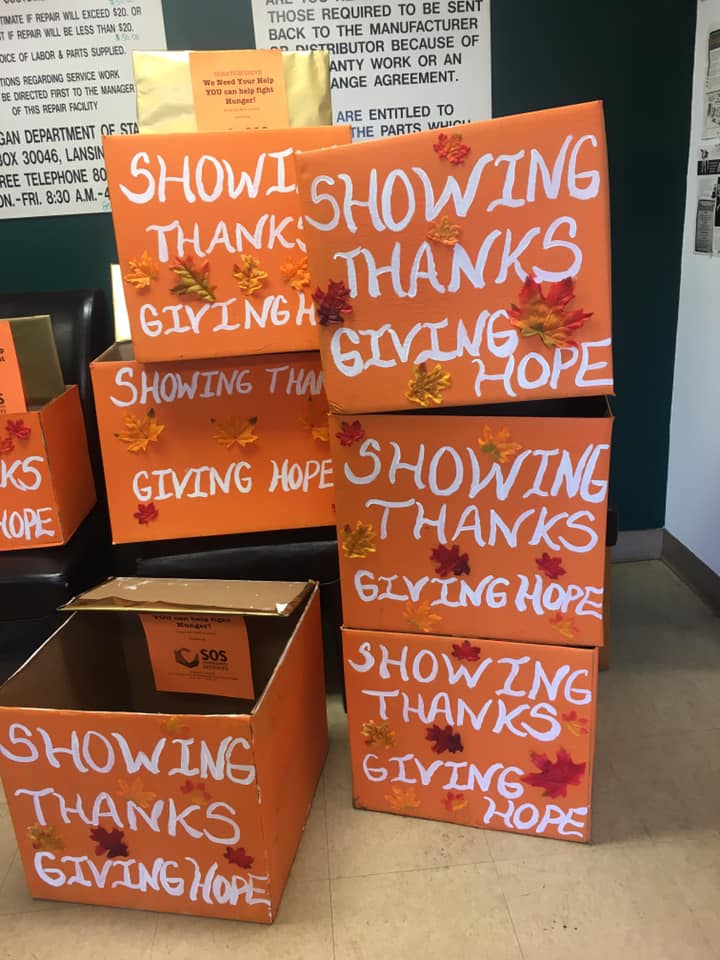 orange boxes decorated with fall leaves and text reading "Showing thanks, giving hope."